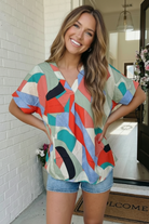 Oversized V-neck top, abstract geometric blouse, women's colorblock shirt, flowy brunch outfit, lightweight summer top, teal and coral blouse, art-inspired fashion, Fabknits boutique.
