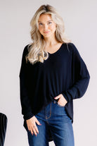 Black loose-fitting sweater with long sleeves and a relaxed silhouette.