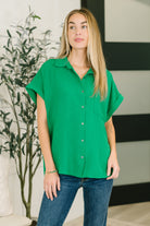 Green button down shirt, crinkle woven blouse, women's short sleeve button down, Kelly green top, casual collared shirt, stepped hem blouse, travel-friendly women's clothing, effortless style green shirt.