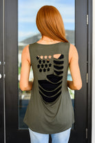 A woman wearing olive green tank top with a v-neckline and a cut-out flag design on the back