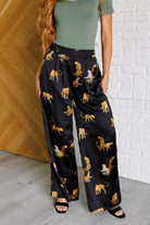 Leopard print pants, satin wide leg trousers, high waisted leopard pants, women's statement trousers, animal print fashion, silky wide leg pants, chic pleated trousers.