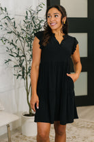 Flutter sleeve dress, black tiered dress, wrinkle resistant dress, summer dress with pockets, Bulgari fabric dress, V-neck dress, travel-friendly fashion.
