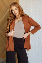 A woman wearing a 3/4 sleeve Blazer in Rust color