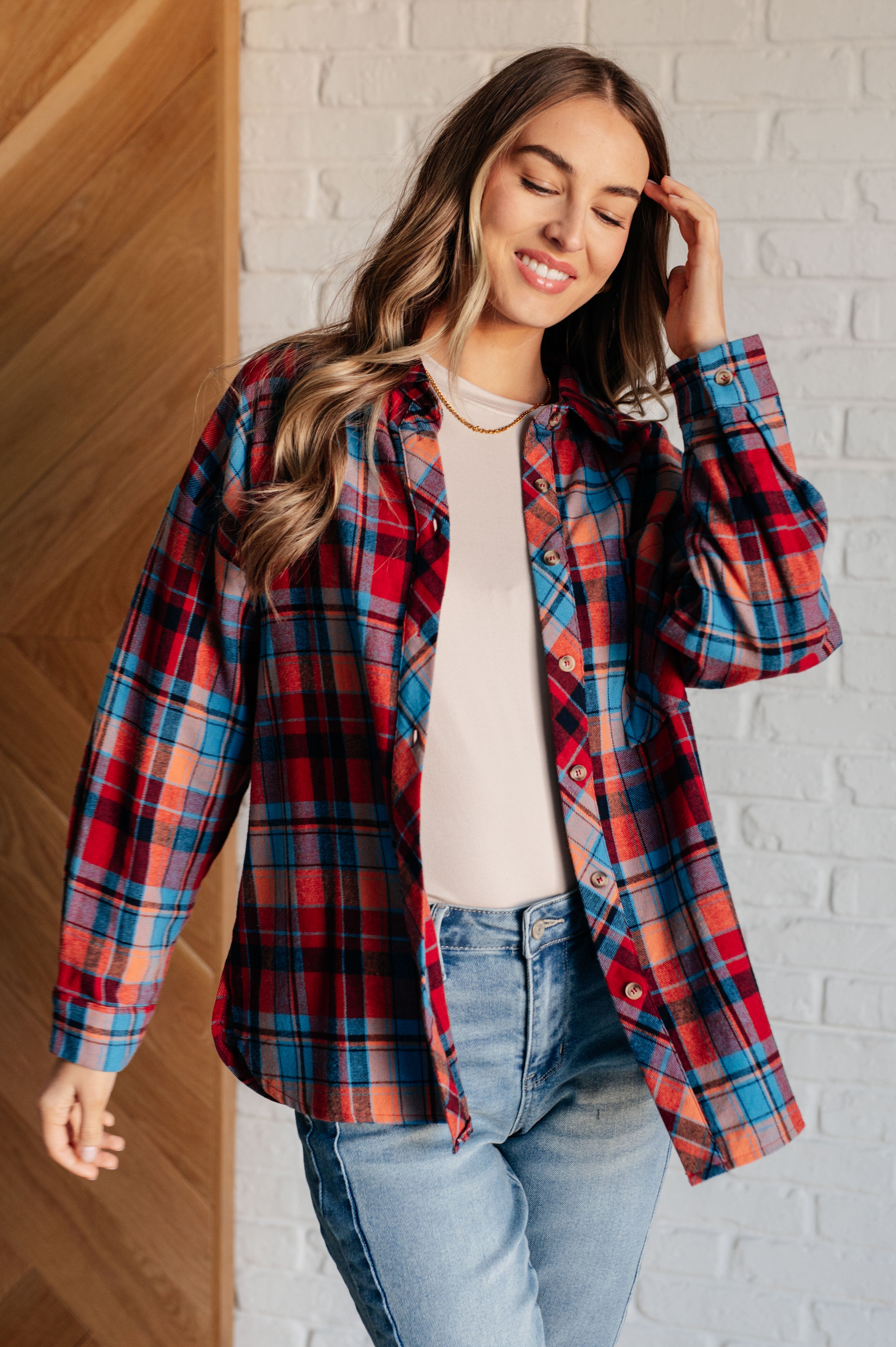 A multicolor plaid button-up shirt with a collared neckline and relaxed fit.