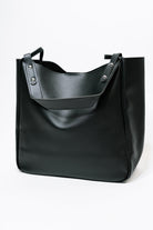 Black shoulder bag, faux leather handbag, vegan leather tote, silver hardware purse, chic everyday bag, minimalist shoulder bag, women's black handbag, stylish commuter bag.