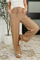 Women wearing tan cargo pants with a white background