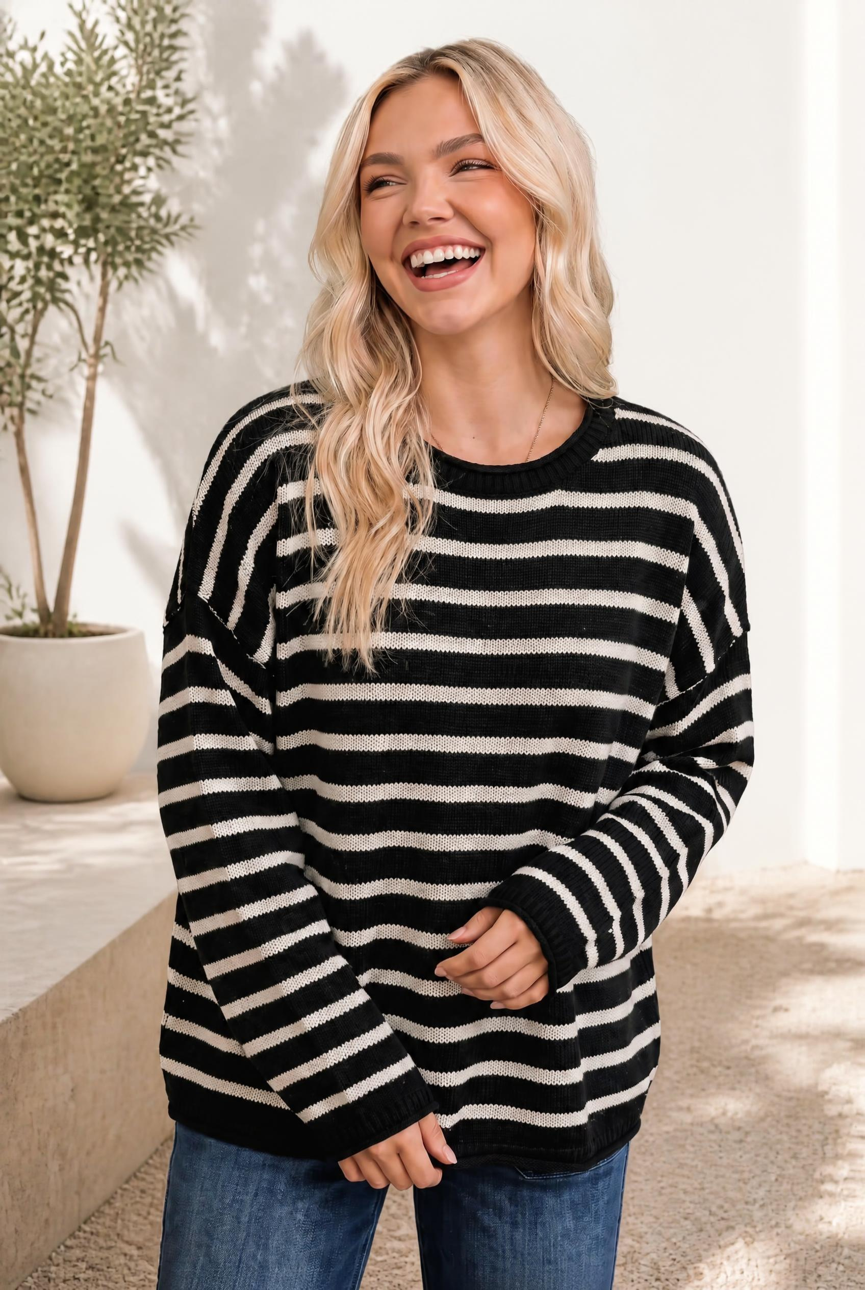 A relaxed knit pullover in black and cream stripes with a crew neckline and ribbed cuffs and hem.