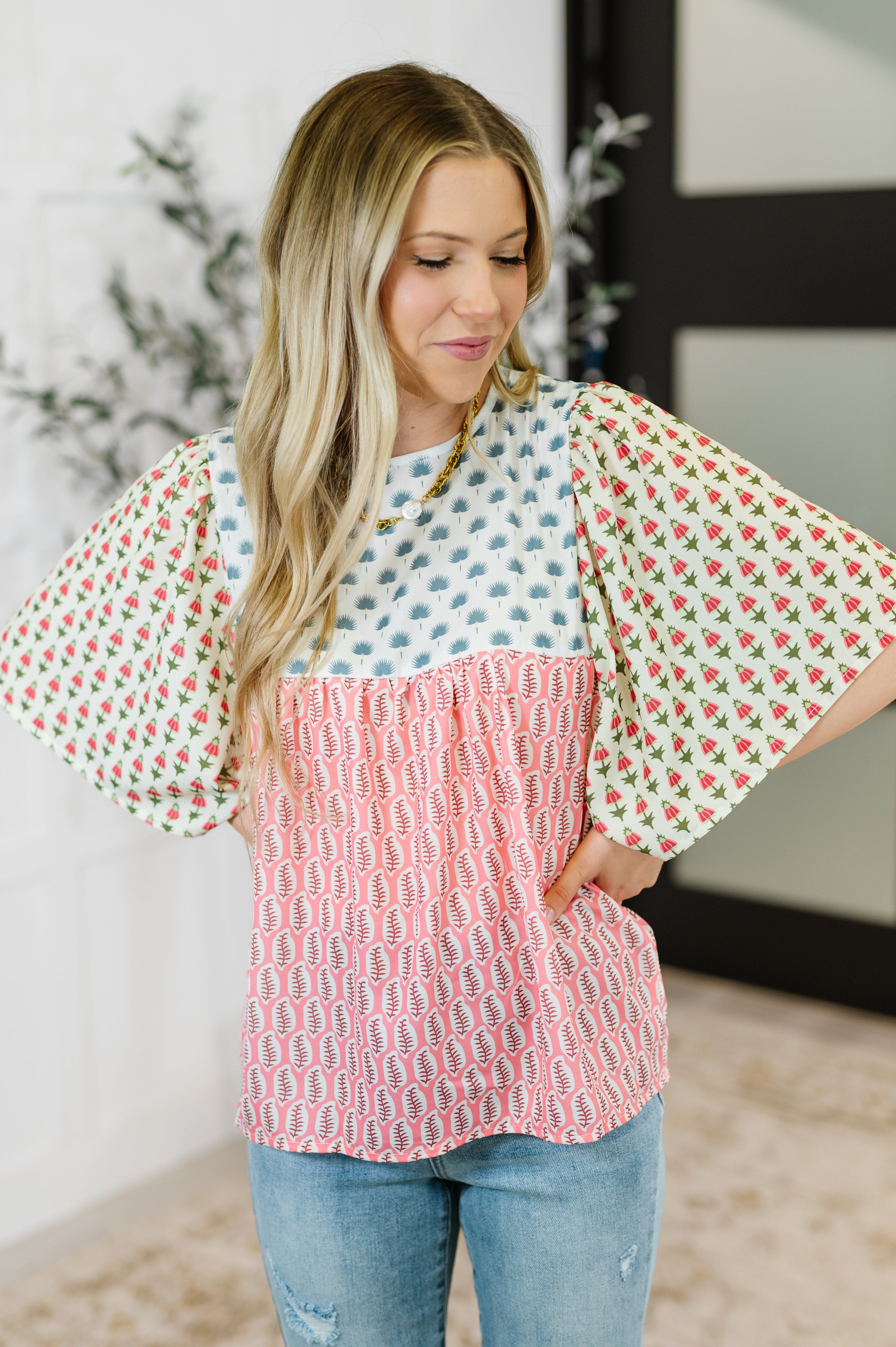 Woman wearing a patterned top with a white background