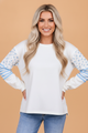 Floral long sleeve top, patchwork pullover, reverse seam top, striped sleeve shirt, women's spring fashion, boho chic layering, casual floral top, breathable cotton blend top, boutique sweatshirts.