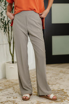 Woman wearing beige pants.