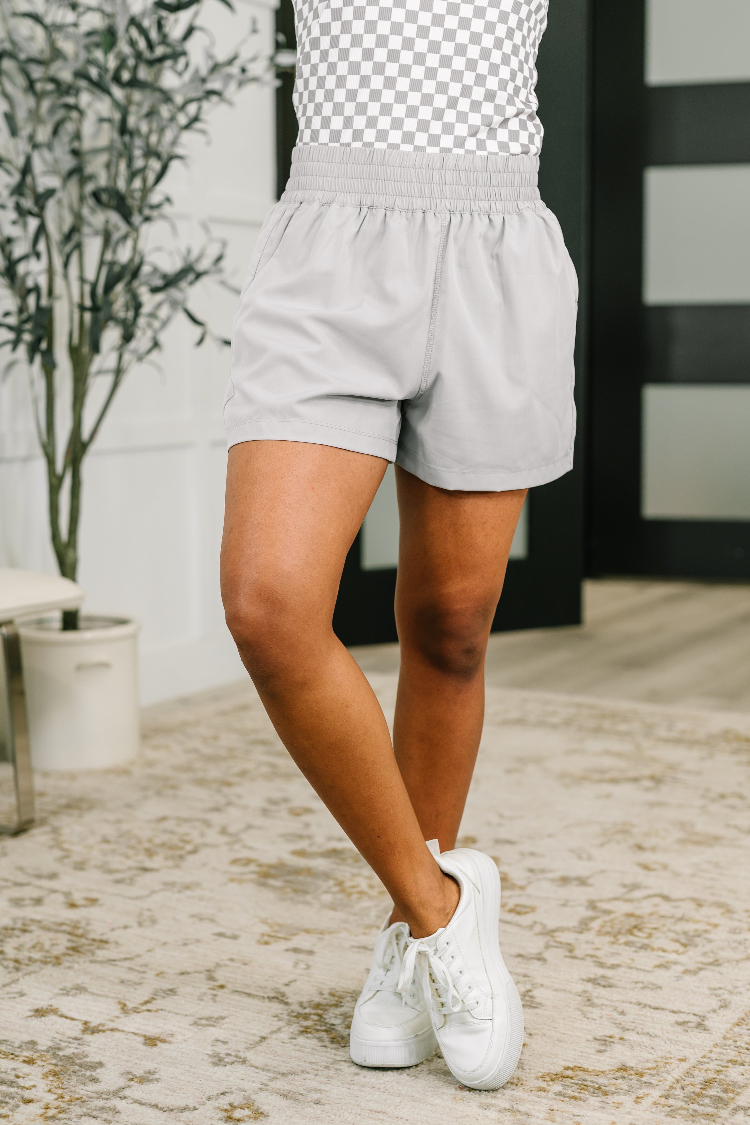 High waisted athletic shorts, women's grey shorts, woven workout shorts, mesh lined shorts, light grey activewear, wide leg sports shorts, functional pocket shorts, casual athletic wear.