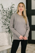Gray textured long sleeve top with a relaxed fit and ribbed round neckline.