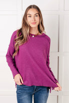 Woman wearing a purple sweater a white background