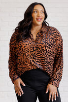A burnout velvet animal print blouse with long dolman sleeves and a collared neckline.