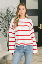 Red and white striped drop shoulder sweater with a round neckline and raw hem.