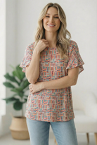 flutter sleeve top, geometric print blouse, brushstroke patterned shirt, colorful casual top, women's relaxed fit blouse, coral and teal top, effortless style, boho chic top