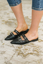 Black pointy toe flat with double buckles and shiny silver hardware.
