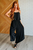 wide leg jumpsuit, tiered jumpsuit, crinkle woven jumpsuit, black jumpsuit, women's boutique fashion, summer one-piece, adjustable strap jumpsuit, jumpsuit with pockets