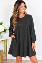 Charcoal long sleeve dress with a fitted silhouette and gentle stretch, worn by a model indoors.