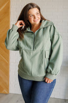 A sage green fleece pullover with a wide collared neckline, half zipper, and snap closure pockets.