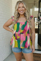 Plus size babydoll top, abstract print blouse, summer fashion, ruffled sleeve top, tiered boho blouse, vibrant women's clothing, flattering plus size tops.
