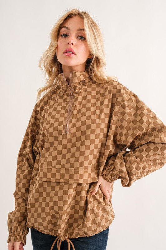 Woman wearing a brown checkered jacket on a white background