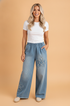 Floral denim, wide leg jeans, raw hem jeans, boho style, women's denim, frayed patch jeans, comfortable jeans, street style fashion, boutique denim, stretch denim pants.