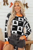 Halloween sweater, ghost pattern sweater, checkered knitwear, women's boutique clothing, spooky season outfit, drop shoulder sweater, orange and black sweater, autumn fashion, ghost motif.