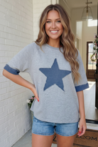 Oversized sweatshirt, denim star patch, heather gray top, women's casual tops, short sleeve sweatshirt, star graphic tee, boxy fit sweater, frayed denim trend.