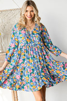 Woman wearing a colorful floral dress in a casual setting