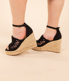A pair of black Juti Espadrille Wedges with platform wedge heels and adjustable buckle closure heel strap, viewed from the side.