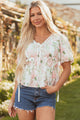 Luxury floral blouse, designer peplum top, puff sleeve blouse, boutique floral top, V-neck summer blouse, elegant garden party attire, exclusive women’s fashion, premium floral top.
