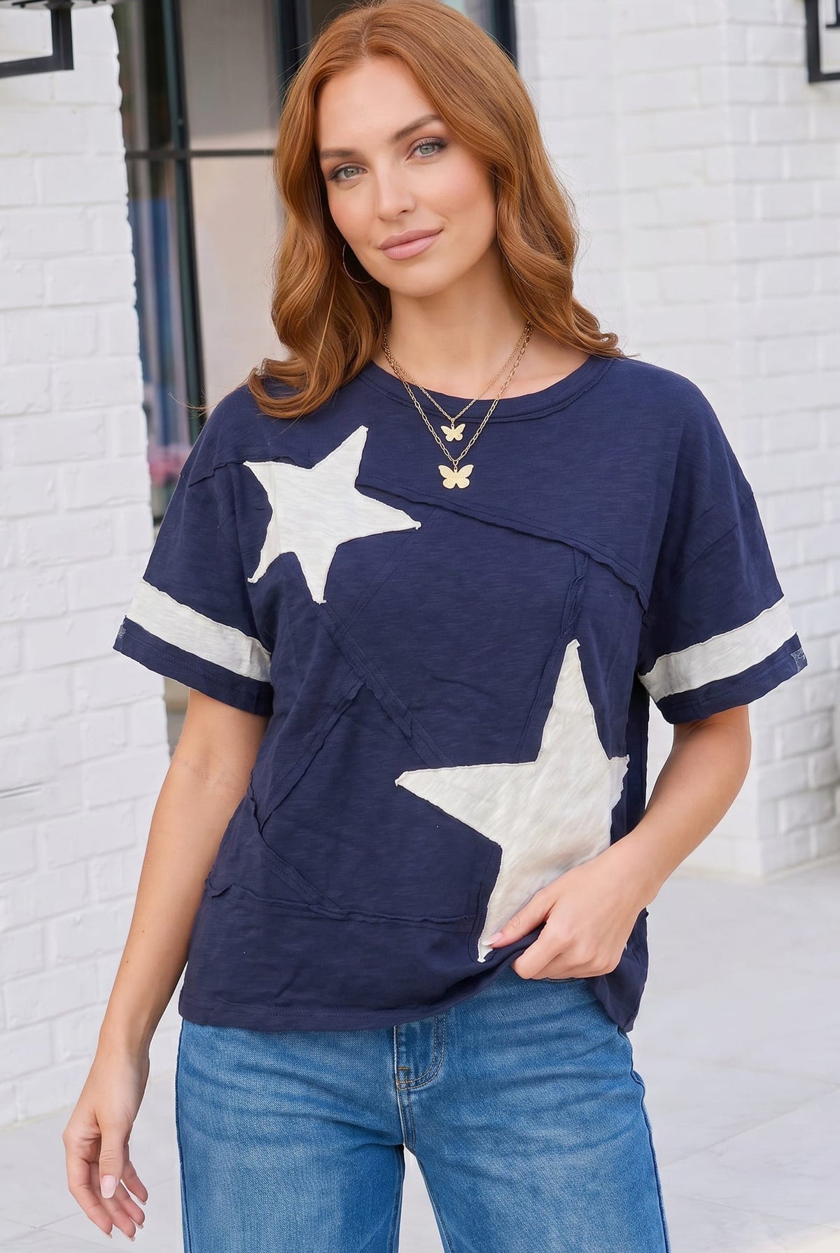 navy varsity tee, star applique shirt, cotton graphic tee, oversized navy top, sporty casual wear, women's varsity t-shirt, raw edge cotton tee, boho sporty style