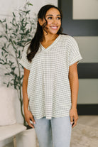 V-neck top, textured knit tee, relaxed fit blouse, women's casual tops, exposed seam shirt, stretchy knit top, short sleeve v-neck, effortless everyday style.