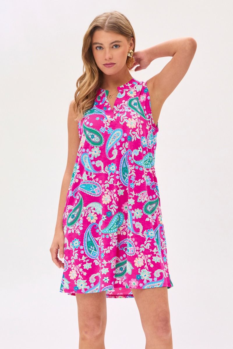 A Woman wearing a hot pink sleeveless tank dress with a floral pattern, featuring a mandarin collar and pleated detail on the back.
