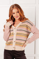 A striped cardigan with a V-neckline and full button front, featuring banded ribbed cuffs and hemline.
