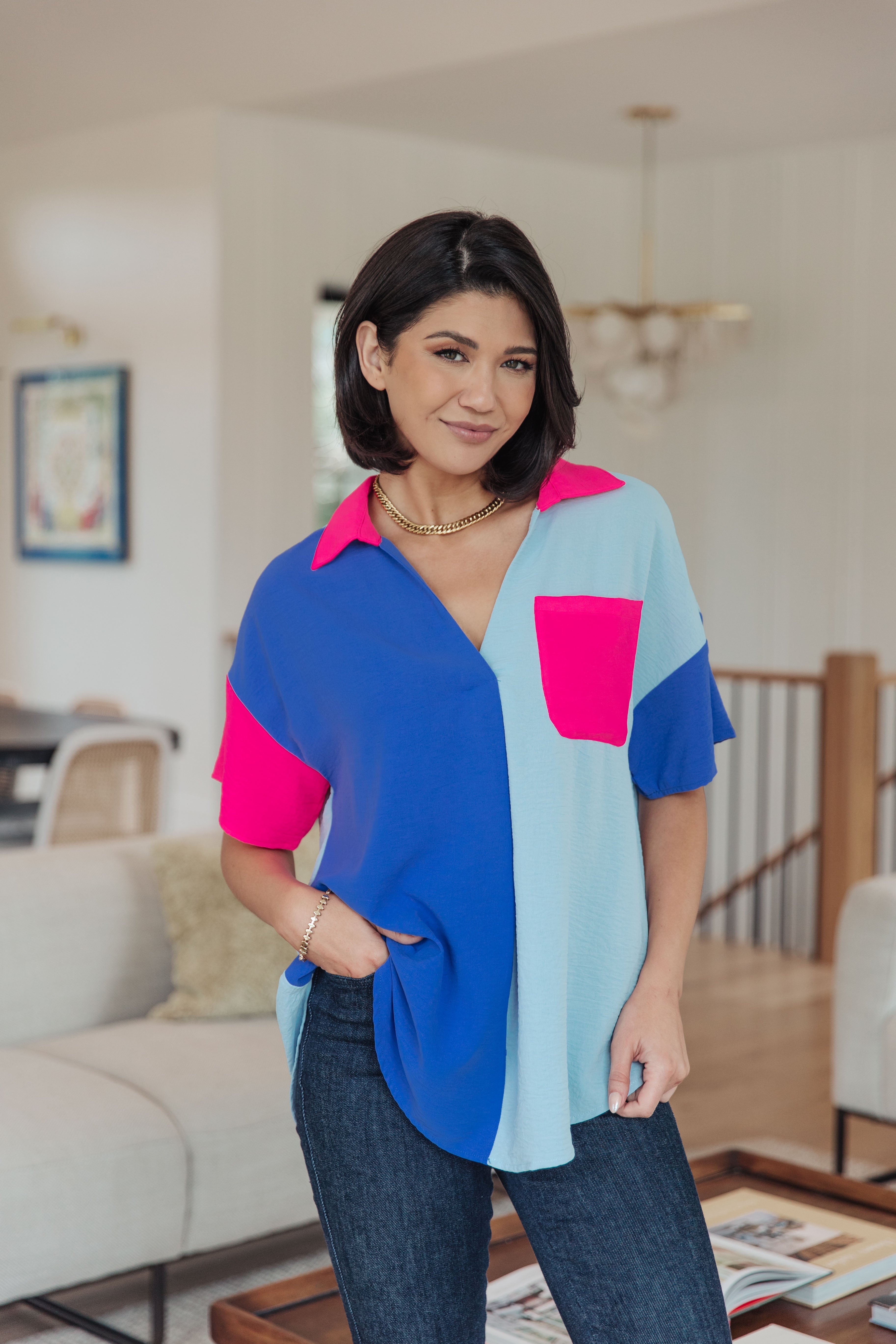 Woman wearing a colorful shirt in a living room setting