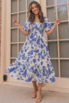 Floral midi dress, smocked summer dress, blue floral sundress, tiered midi dress with pockets, flutter sleeve dress, casual summer fashion, brunch outfit ideas, 100% polyester dress.