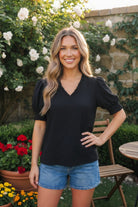black puff sleeve top, smocked sleeve blouse, ruffled v-neck top, textured black blouse, women's relaxed fit top, feminine summer blouse, Bloom & Unwind clothing, chic black top