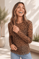 A long sleeve leopard print mesh top with a relaxed fit and lettuce hem.
