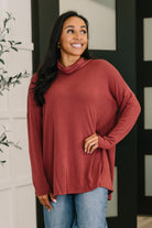 Wine-colored cowl neck pullover with drop shoulders and a tulip open back, worn by a smiling model.