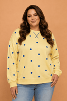 Plus size sweatshirt, polka dot pullover, women’s casual tops, long sleeve sweatshirt, split hem top, cozy plus size fashion, trendy plus size clothing, yellow polka dot top.