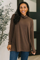 Chocolate cowl neck pullover with long sleeves and a relaxed fit, featuring a tulip open back.