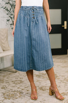 Blue high waisted skirt with vertical stripes, button closures, and drawstrings.