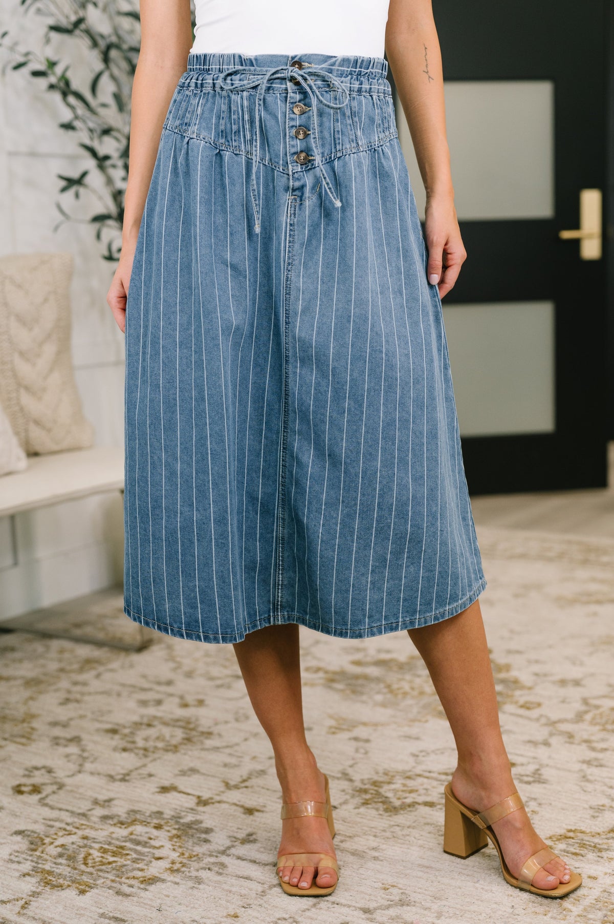 Blue high waisted skirt with vertical stripes, button closures, and drawstrings.
