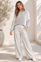 A grey lounge set with lace detailing, color block paneling, and an oversized fit.