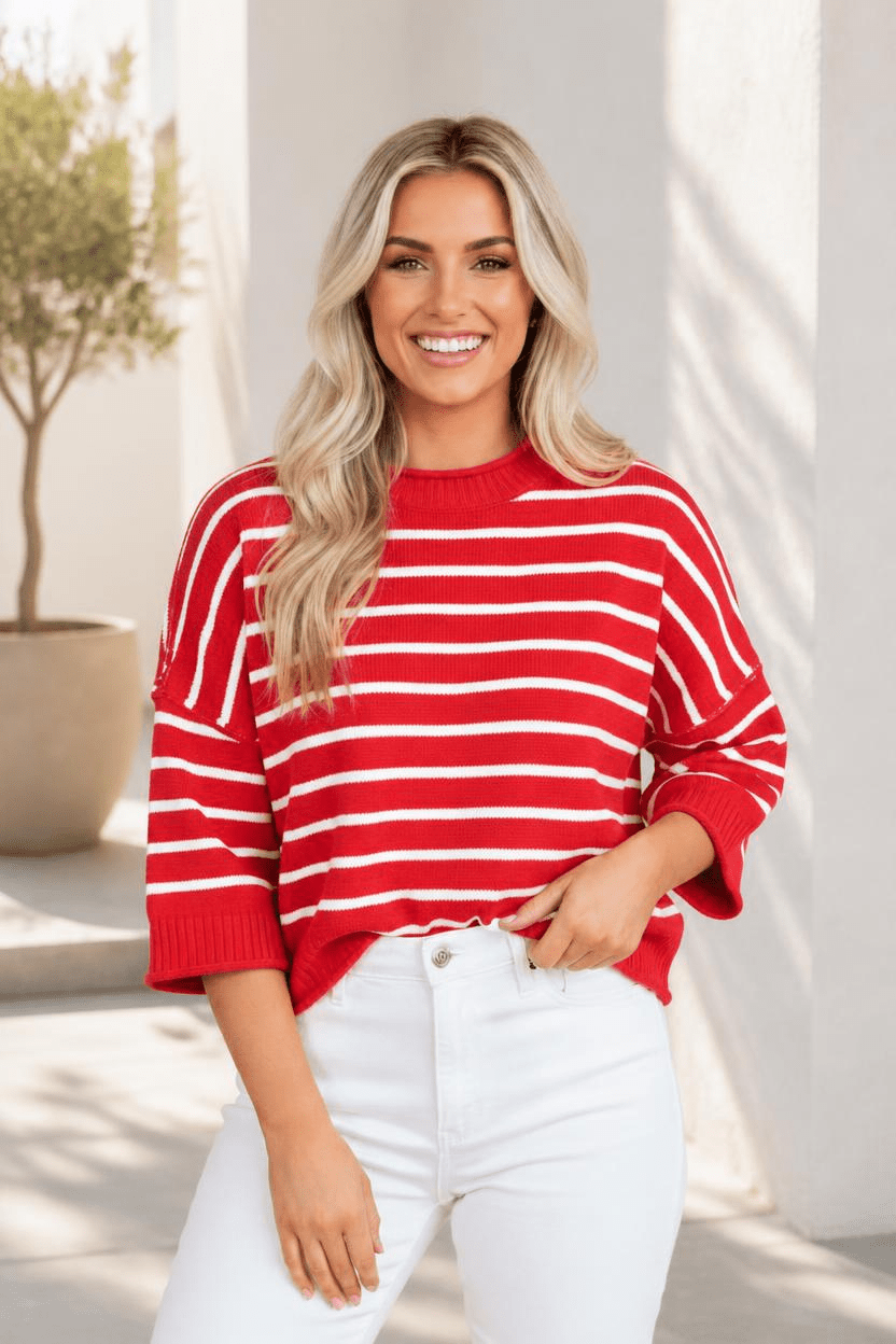 Red and white striped knit top with drop-shoulder design and ribbed detailing.
