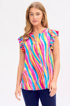 A woman wearing a multicolored striped flutter sleeve top with a mandarin collar.