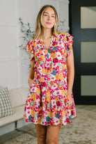 Floral mini dress, flutter sleeve dress, tiered floral dress, dress with pockets, crinkle woven dress, garden party dress, spring floral fashion, women's brunch dress, viscose floral dress, ruffled V-neck dress.