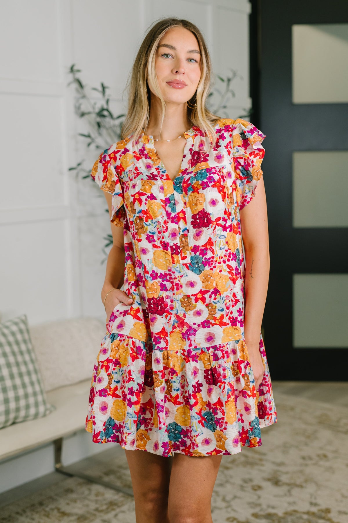 Floral mini dress, flutter sleeve dress, tiered floral dress, dress with pockets, crinkle woven dress, garden party dress, spring floral fashion, women's brunch dress, viscose floral dress, ruffled V-neck dress.